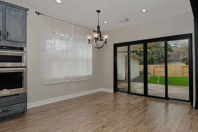 interior space with a chandelier and light hardwood / wood-style flooring