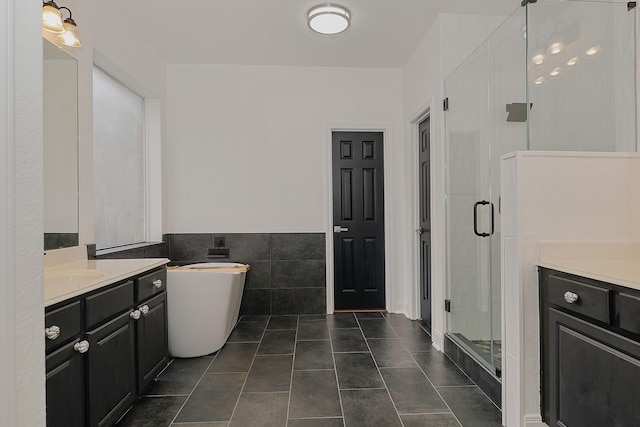 bathroom featuring separate shower and tub, tile walls, tile patterned flooring, and vanity