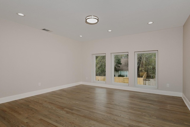 unfurnished room with wood-type flooring