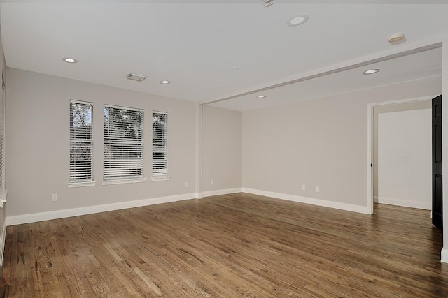 unfurnished room with hardwood / wood-style flooring