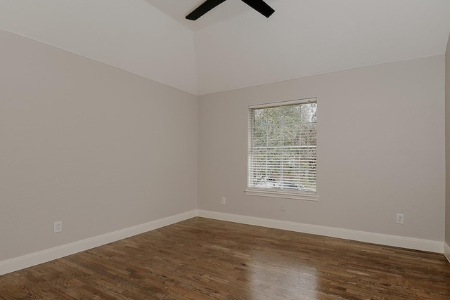 empty room featuring ceiling fan, dark hardwood / wood-style flooring, and vaulted ceiling