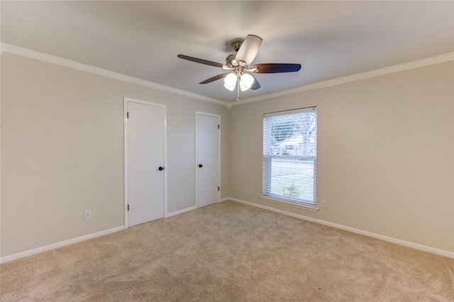 unfurnished bedroom featuring ceiling fan, ornamental molding, and light carpet