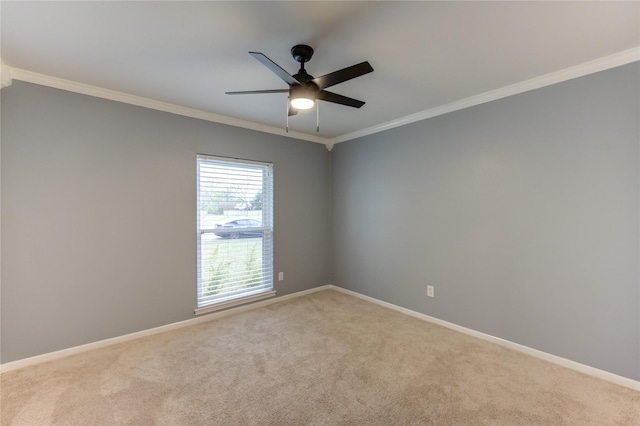 carpeted empty room featuring ceiling fan and ornamental molding