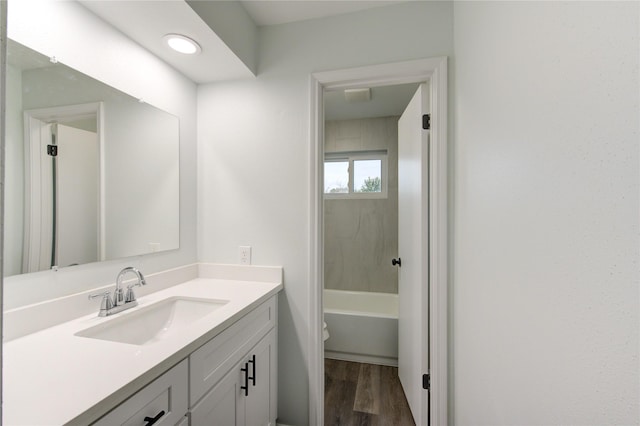 bathroom featuring wood-type flooring, toilet, and vanity