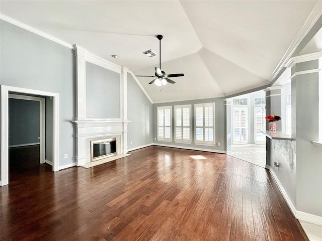 unfurnished living room featuring visible vents, wood finished floors, vaulted ceiling, crown molding, and a fireplace