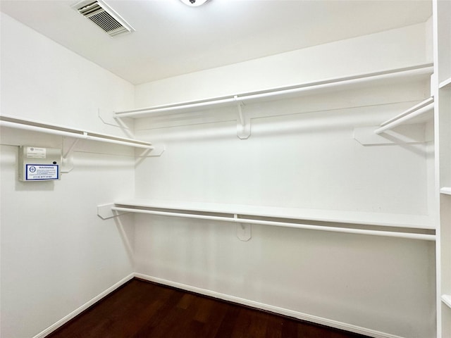 walk in closet with dark wood-type flooring and visible vents