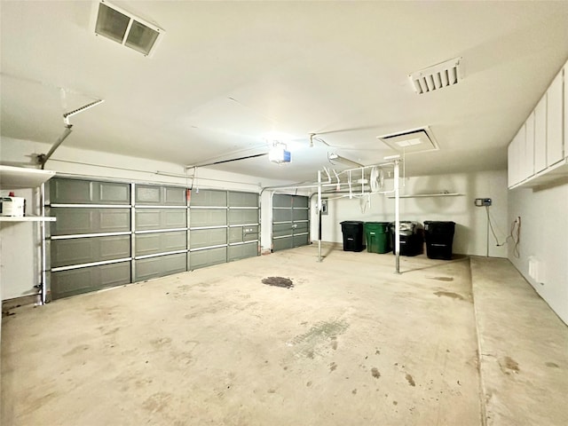 garage with visible vents and a garage door opener