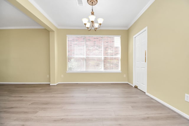 spare room with crown molding, light hardwood / wood-style floors, and a chandelier