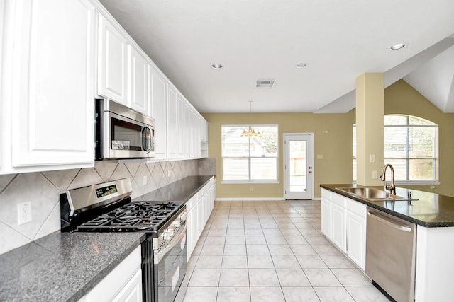 kitchen featuring sink, white cabinets, light tile patterned floors, and stainless steel appliances