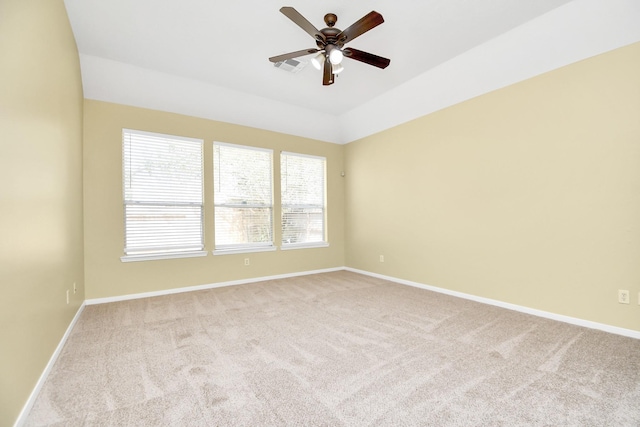 unfurnished room with ceiling fan, light colored carpet, and vaulted ceiling