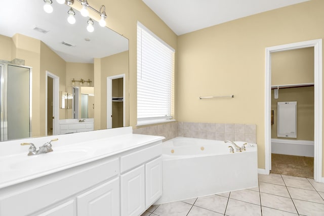 bathroom featuring vanity, tile patterned floors, and plus walk in shower