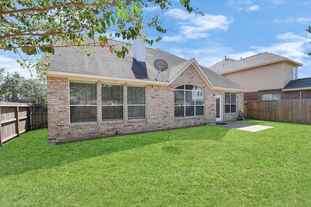 rear view of house with a lawn