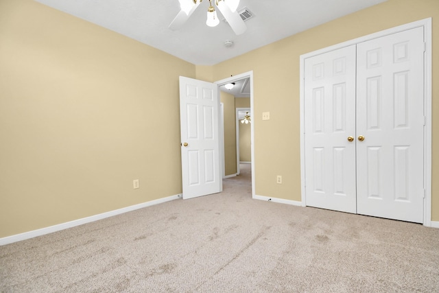 unfurnished bedroom featuring ceiling fan, light colored carpet, and a closet