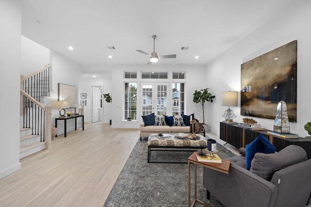 living room with ceiling fan, french doors, and light hardwood / wood-style floors