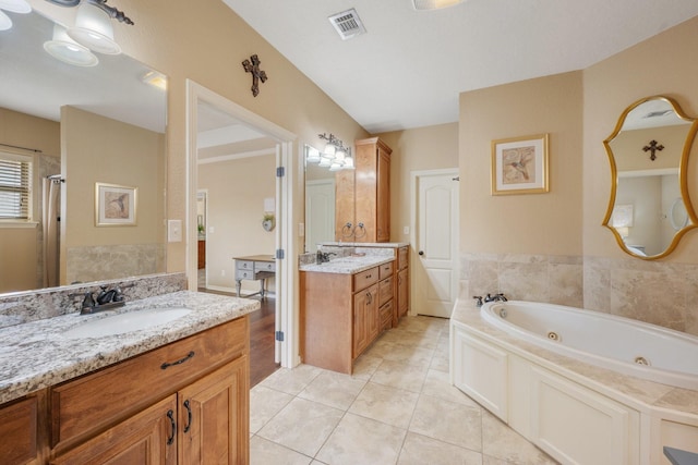 bathroom with tile patterned flooring, a whirlpool tub, visible vents, a sink, and two vanities