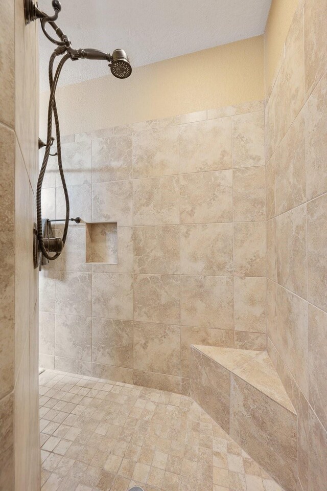 full bathroom with tiled shower