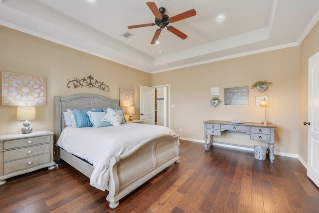 bedroom featuring wood finished floors, visible vents, and a raised ceiling