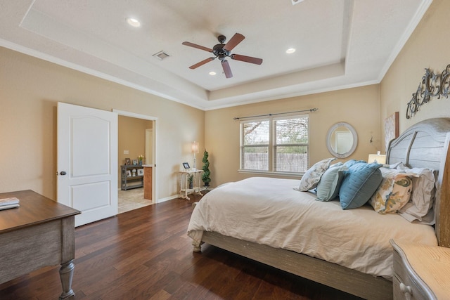 bedroom featuring visible vents, wood finished floors, a tray ceiling, and recessed lighting