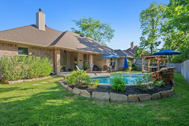 rear view of house featuring a lawn, a fenced backyard, a fenced in pool, and roof with shingles
