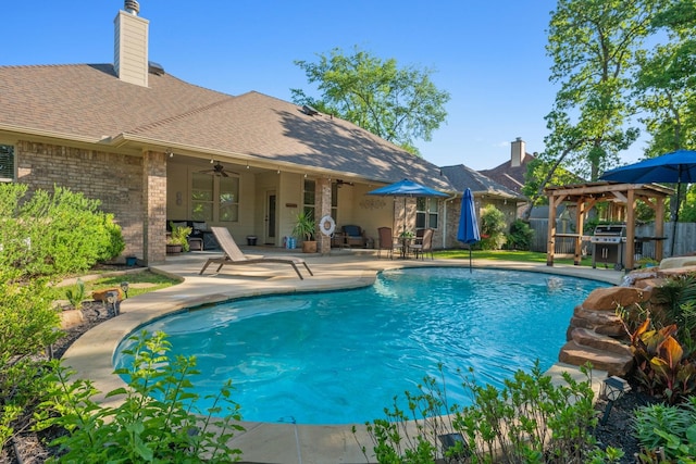 view of swimming pool with a gazebo, a ceiling fan, fence, a patio, and a fenced in pool