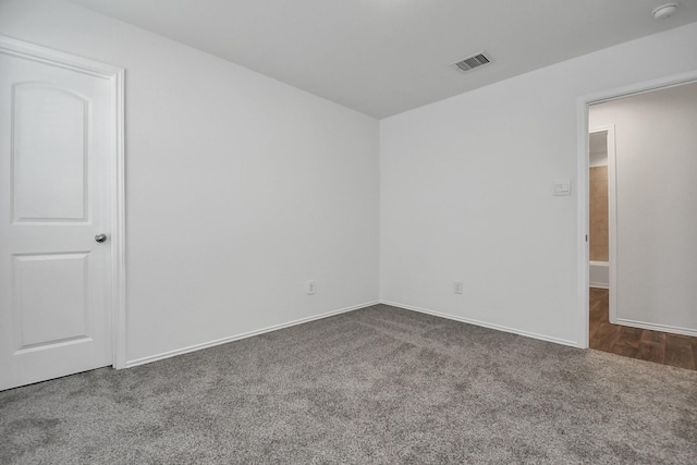 empty room with dark colored carpet