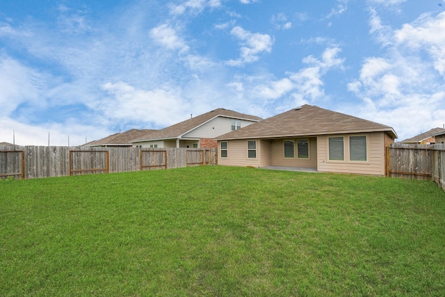 rear view of house featuring a yard