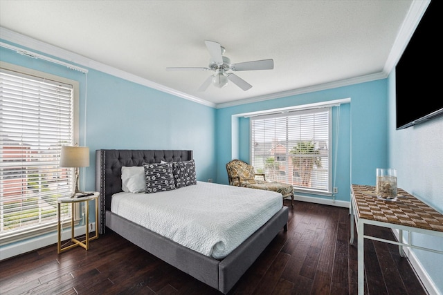 bedroom with dark hardwood / wood-style flooring, ceiling fan, and ornamental molding