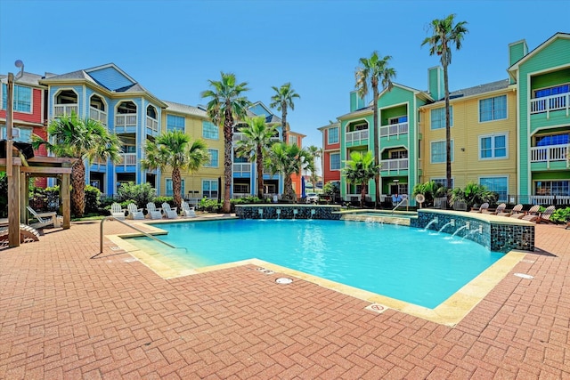 view of pool with a patio area and pool water feature