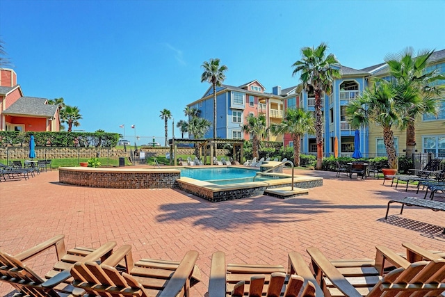 view of property's community featuring a pergola and a hot tub