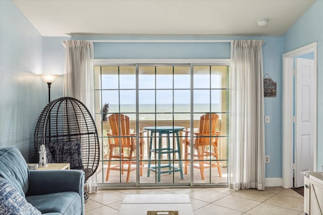 doorway to outside featuring light tile patterned floors and a water view