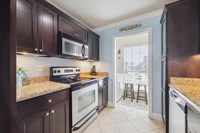 kitchen with crown molding, light stone countertops, light tile patterned floors, dark brown cabinetry, and stainless steel appliances