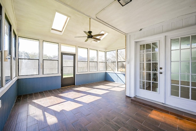 unfurnished sunroom featuring ceiling fan and lofted ceiling with skylight