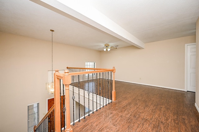 hall with beamed ceiling and dark hardwood / wood-style flooring