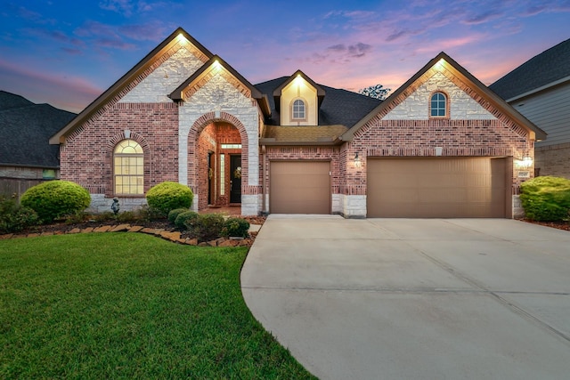 view of front of house with a yard and a garage