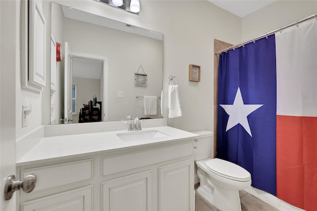 bathroom with toilet, walk in shower, and vanity