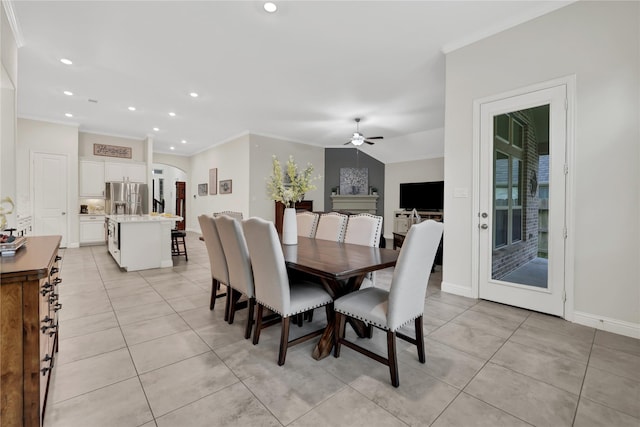 dining room featuring ceiling fan, ornamental molding, and light tile patterned floors