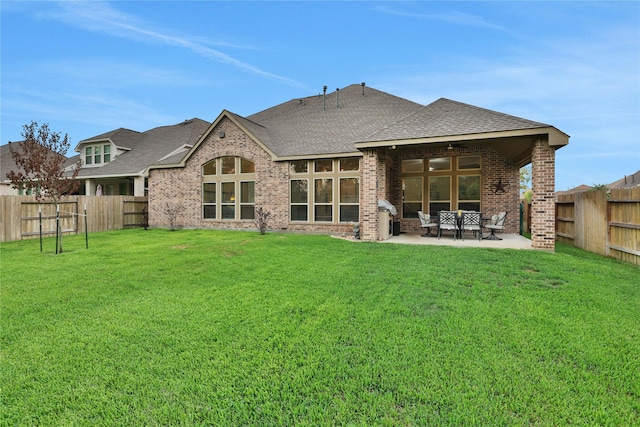 back of house with a patio and a yard