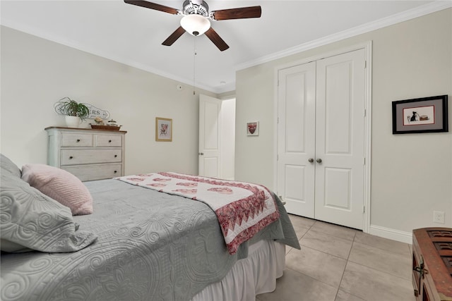 tiled bedroom featuring a closet, ceiling fan, and ornamental molding