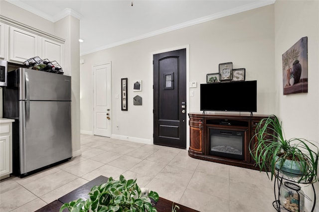 kitchen featuring crown molding, light tile patterned flooring, white cabinets, and stainless steel appliances