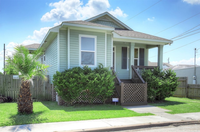 bungalow-style home with a front yard and a porch