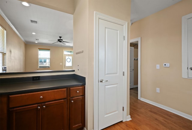 kitchen featuring ceiling fan, light hardwood / wood-style flooring, and crown molding