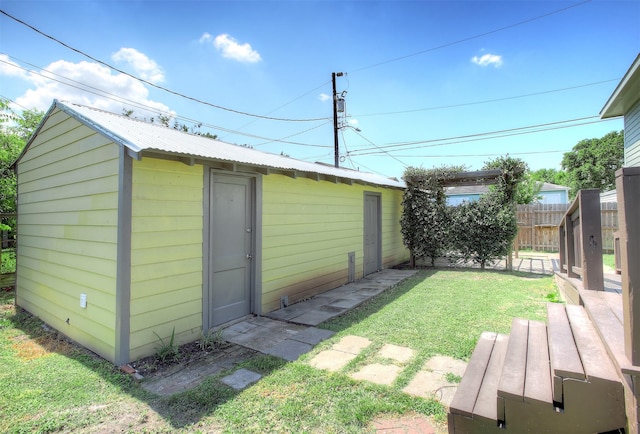 view of outbuilding with a yard