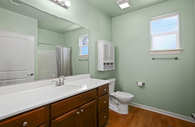 bathroom with curtained shower, hardwood / wood-style floors, toilet, and vanity