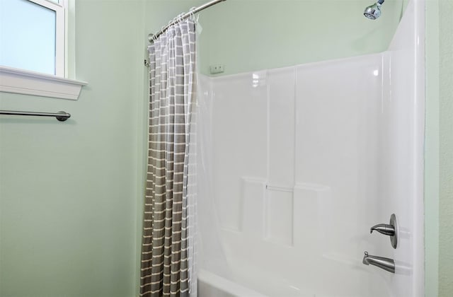 bathroom with shower / bath combo with shower curtain