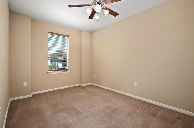 empty room with ceiling fan and light carpet