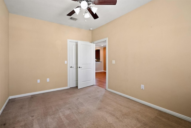 unfurnished bedroom featuring carpet flooring and ceiling fan