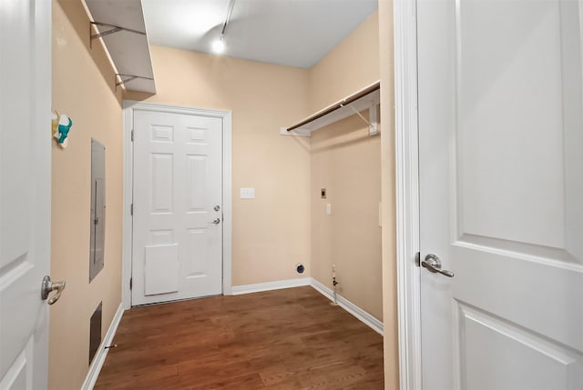 laundry area featuring electric panel, electric dryer hookup, and hardwood / wood-style floors