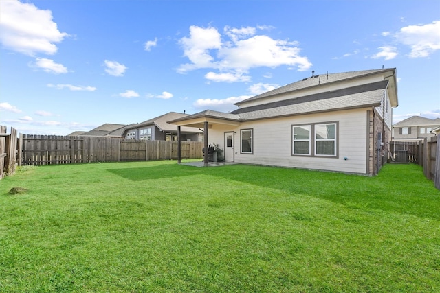 rear view of house with a yard