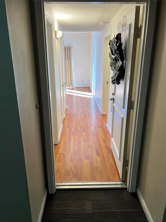 corridor featuring wood-type flooring