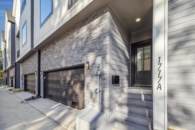 view of exterior entry with a garage